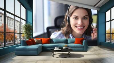 Female customer support operator with headset and smiling. Wall mural