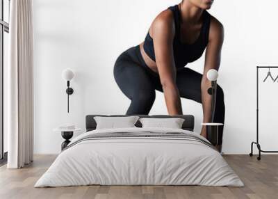 Fit and muscular African woman focused on lifting a dumbbell during an exercise class on a transparent background Wall mural