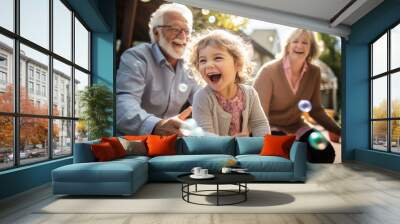 Grandmother and grandfather playing end enjoying with their granddaughter in the yard of the house Wall mural