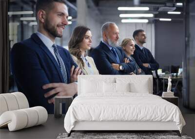 Happy smiling business team standing in a row at office. Wall mural