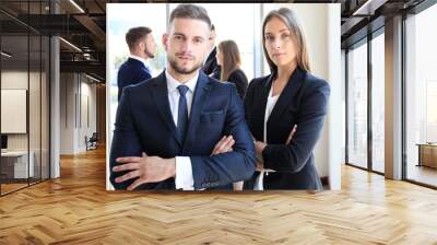 Image of two business partners with colleagues in the background Wall mural