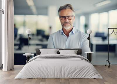 portrait of middle aged businessman smiling at the computer Wall mural