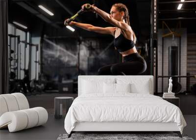 Sporty woman making squats on balance trainer. Wall mural