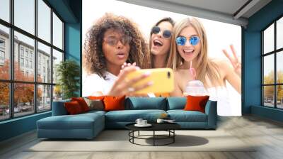 Three cute young girls friends having fun together, taking a selfie on a transparent background. Wall mural