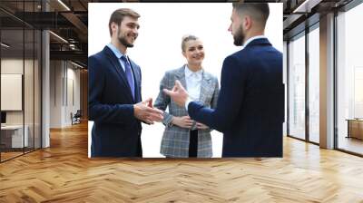 Three young businessmen standing discussing business on a transparent background Wall mural