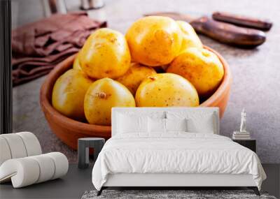 bowl with raw potatoes on a table Wall mural