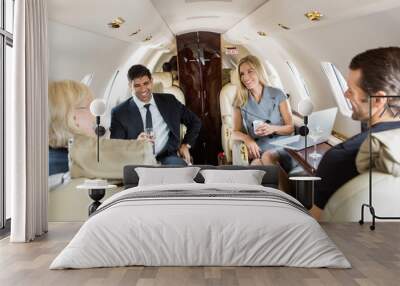 business professionals having drinks on private jet Wall mural