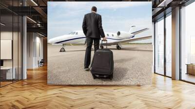 Businessman Walking Towards Corporate Jet Wall mural