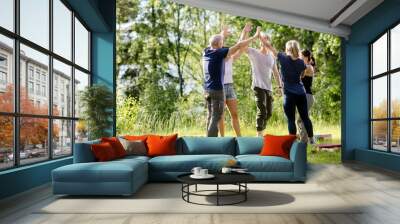 Coworkers Giving High-Five After Playing With Building Blocks On Wall mural