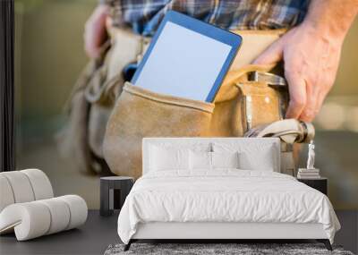 Digital Tablet And Hammer In Carpenter's Tool Belt Wall mural