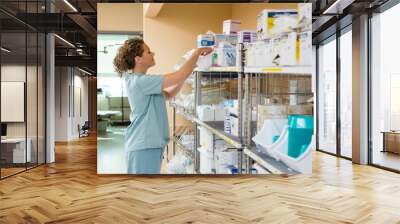 Female Nurse Working In Storage Room Wall mural