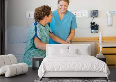 Nurse Assisting Patient Using Walking Frame In Hospital Wall mural