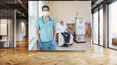 Nurse In Protective Clothing With Patient Receiving Dialysis Wall mural