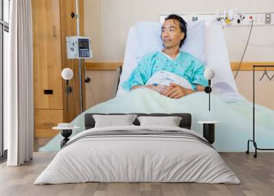 Patient Reclining On Bed While Looking Away In Hospital Wall mural