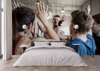 People Giving High Five To Each Other In Gymnasium Wall mural