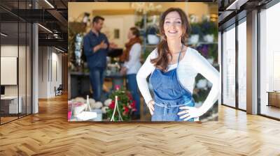 portrait of smiling female owner at flower shop Wall mural