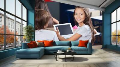 Schoolgirl Holding Digital Tablet At Desk Wall mural