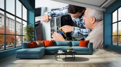 Teacher And Senior Man Fixing Computer In Class Wall mural