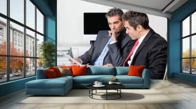 thoughtful businessmen using digital tablet at desk Wall mural