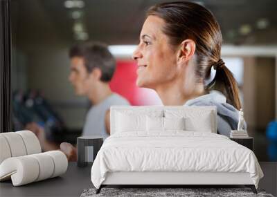 Woman And Man Running On Treadmill Wall mural