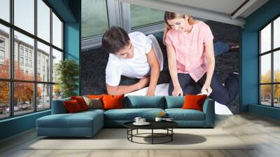 young couple looking at blueprints Wall mural