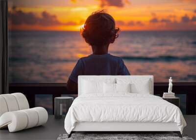 Silhouette of a child standing on a balcony overlooking the ocean Wall mural