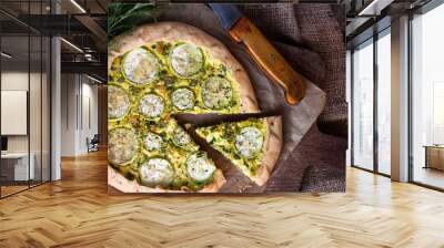 Homemade courgette and goat cheese pie on a dark rustic wooden board background Wall mural