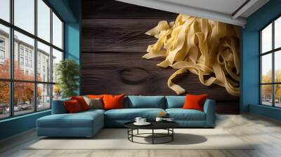 Raw tagliatelle pasta on wooden background Wall mural