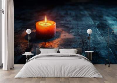 A candle is lit on a wooden table Wall mural