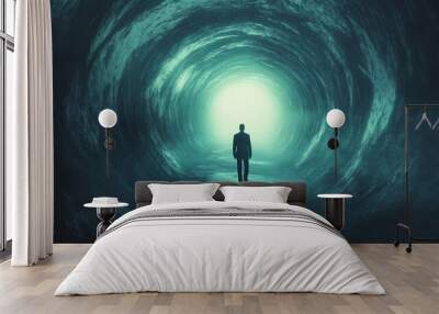 A man is walking through a tunnel with a light at the end Wall mural