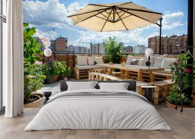 Patio with cute, cozy pallet furniture and colorful pillows on a rooftop in summer Wall mural