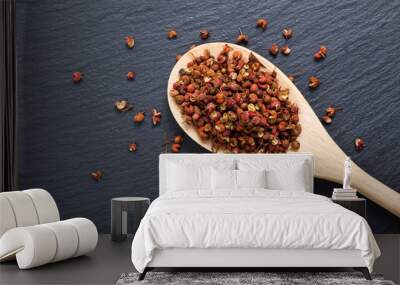 Chinese pepper, Sichuan pepper in wooden spoon on black slate stone plate with copy space Wall mural