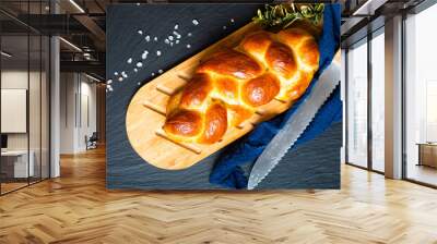 Homemade food concept fresh baked bread braid challah or brioche on black slate stone with copy space Wall mural