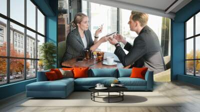 Two businessman and businesswoman couple meeting in co working space or office Wall mural