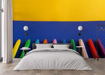 Frame of crayons on the blue background.Empty space.Creative time for kids Wall mural