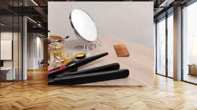 Set of hair dressing tools,cosmetcs,make up accessories and mirror on the wooden table against bath wall.Empty space Wall mural