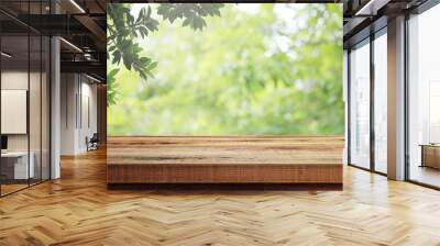 Wooden desk and blurred green nature in garden background.  Wall mural