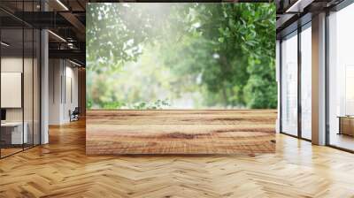 Wooden table and blurred green nature garden background. Wall mural