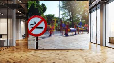 No smoking sign with colorful exercise equipment in public park Wall mural