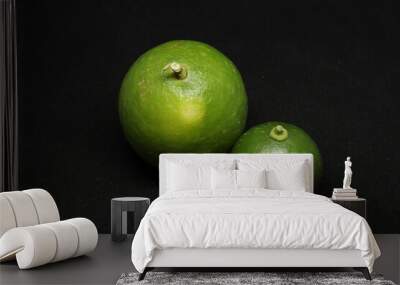 green Lemons fruit. on a black background Wall mural