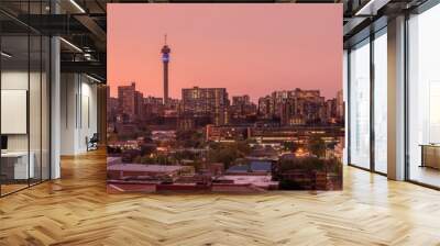 A beautiful and dramatic panoramic photograph of the Johannesburg city skyline, taken on a golden evening after sunset. Wall mural