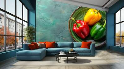 Red, yellow and green bell peppers arranged on a green ceramic dish, bell peppers, red, yellow, green, vegetables Wall mural