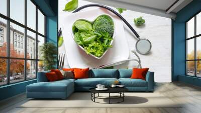 Healthy green diet in the heart concept with stethoscope Wall mural