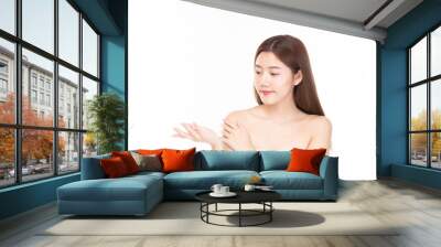 Beautiful spa model girl with perfect fresh clean skin. Beauty woman face portrait showing empty copy space on the open hand palm for text  on white background. Wall mural