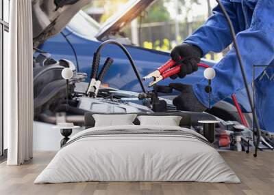 Close up of hand mechanic car service battery with electricity through jumper cables. Service work by professional technicians concept. Wall mural