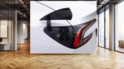 Fast charging socket type 2 combo electric car. Eco friendly alternative energy green environment concept. Type 2 CCS plug port on electric vehicle. DC - CCS type 2 EV charging connector at EV car Wall mural