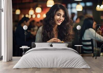 A woman enjoying a delicious meal at a table Wall mural