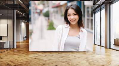 Summer sunny lifestyle fashion portrait of young stylish hipster woman walking on the street, wearing cute trendy outfit Wall mural