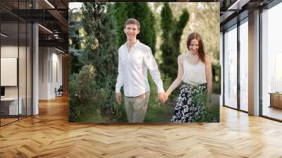 The young couple walking in the park Wall mural