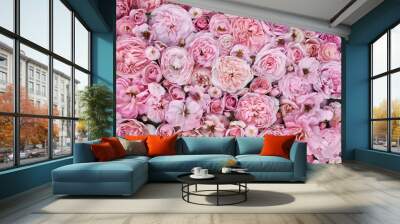 Delicate blooming festive light roses on pink background, blossoming flowers soft pastel frame, bouquet floral card Wall mural